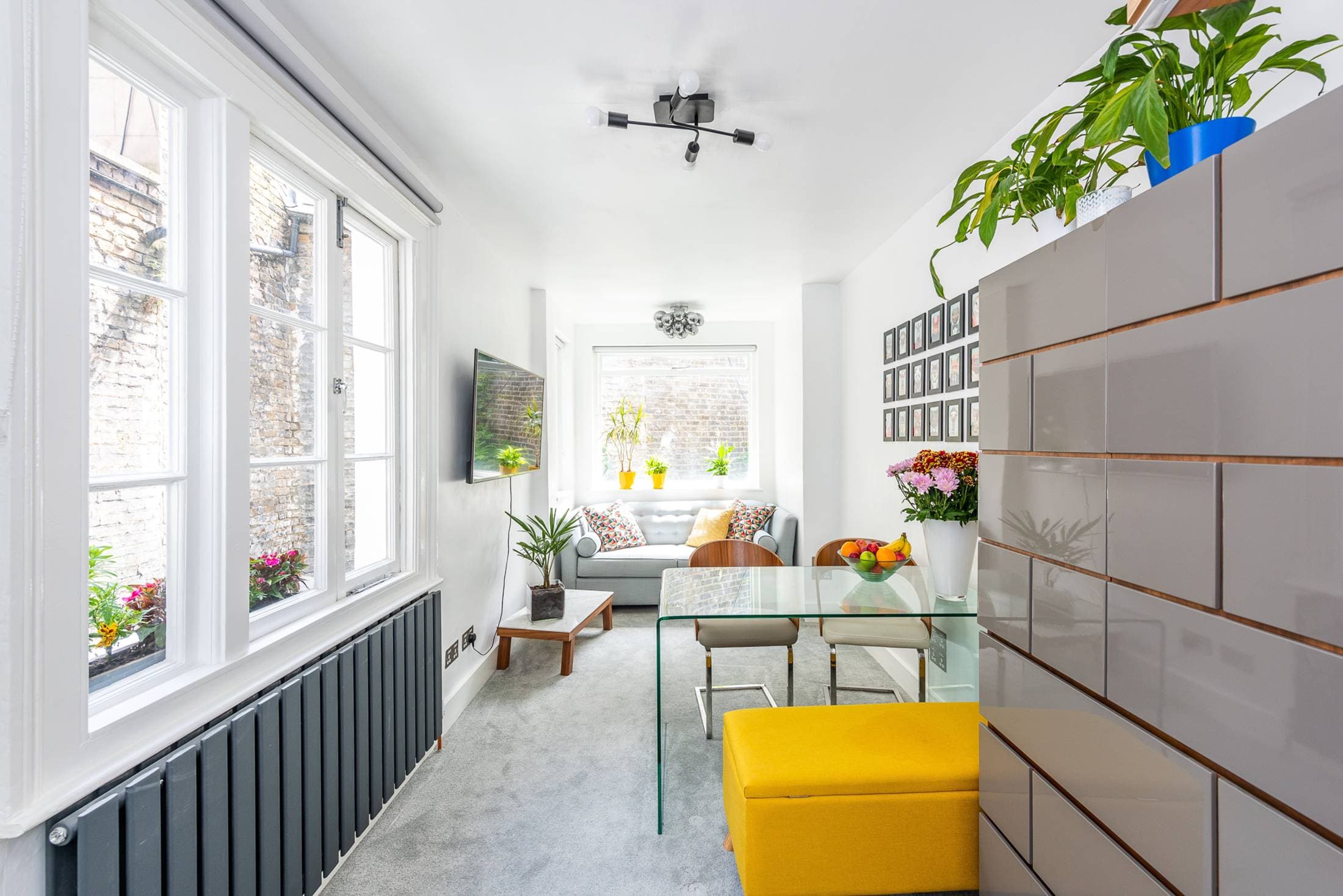 Bright open-plan living room with large windows facing the back garden