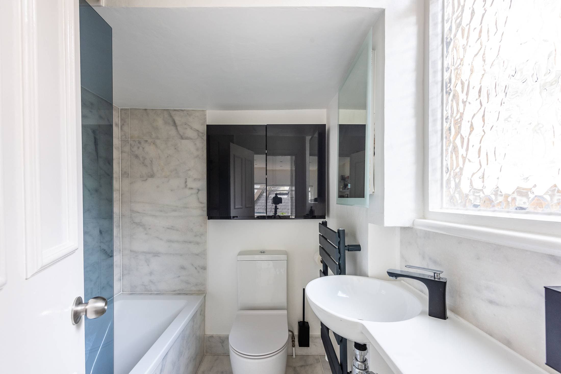 Marble bathroom upstairs with rainfall shower and bathtub