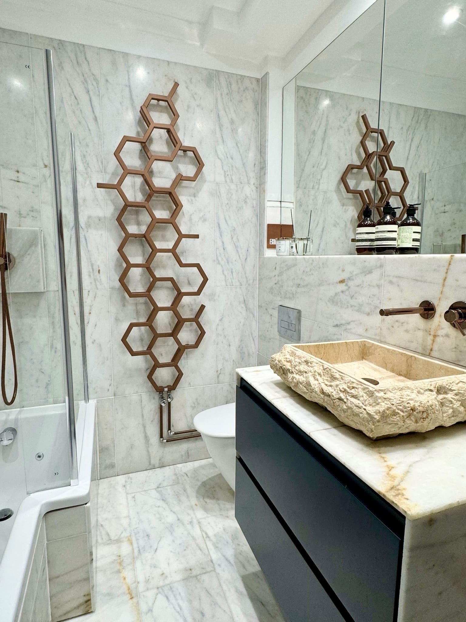 Marble bathroom with jacuzzi bath, rainfall shower and washer-dryer