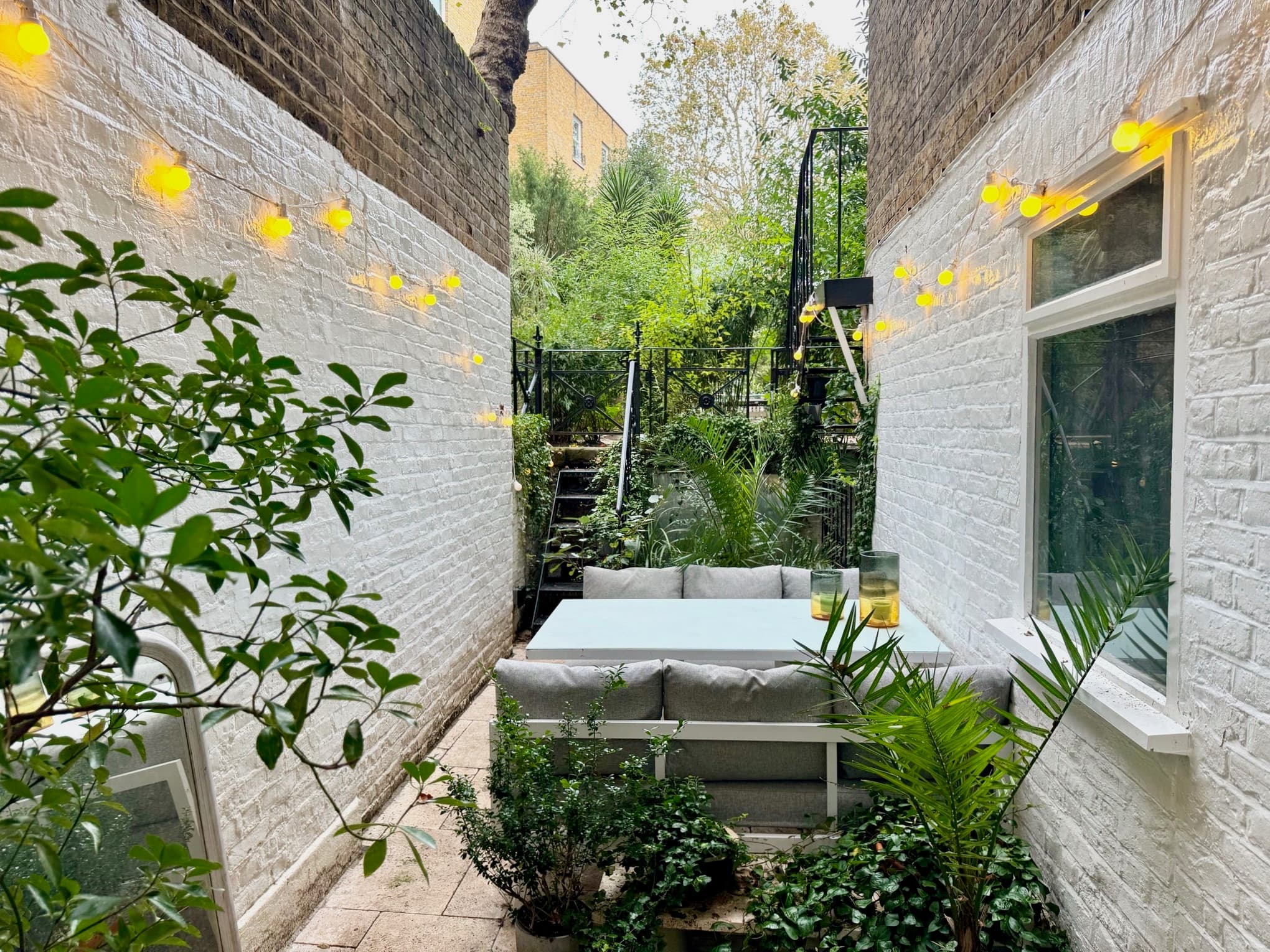 Private outdoor patio with dining area and water feature
